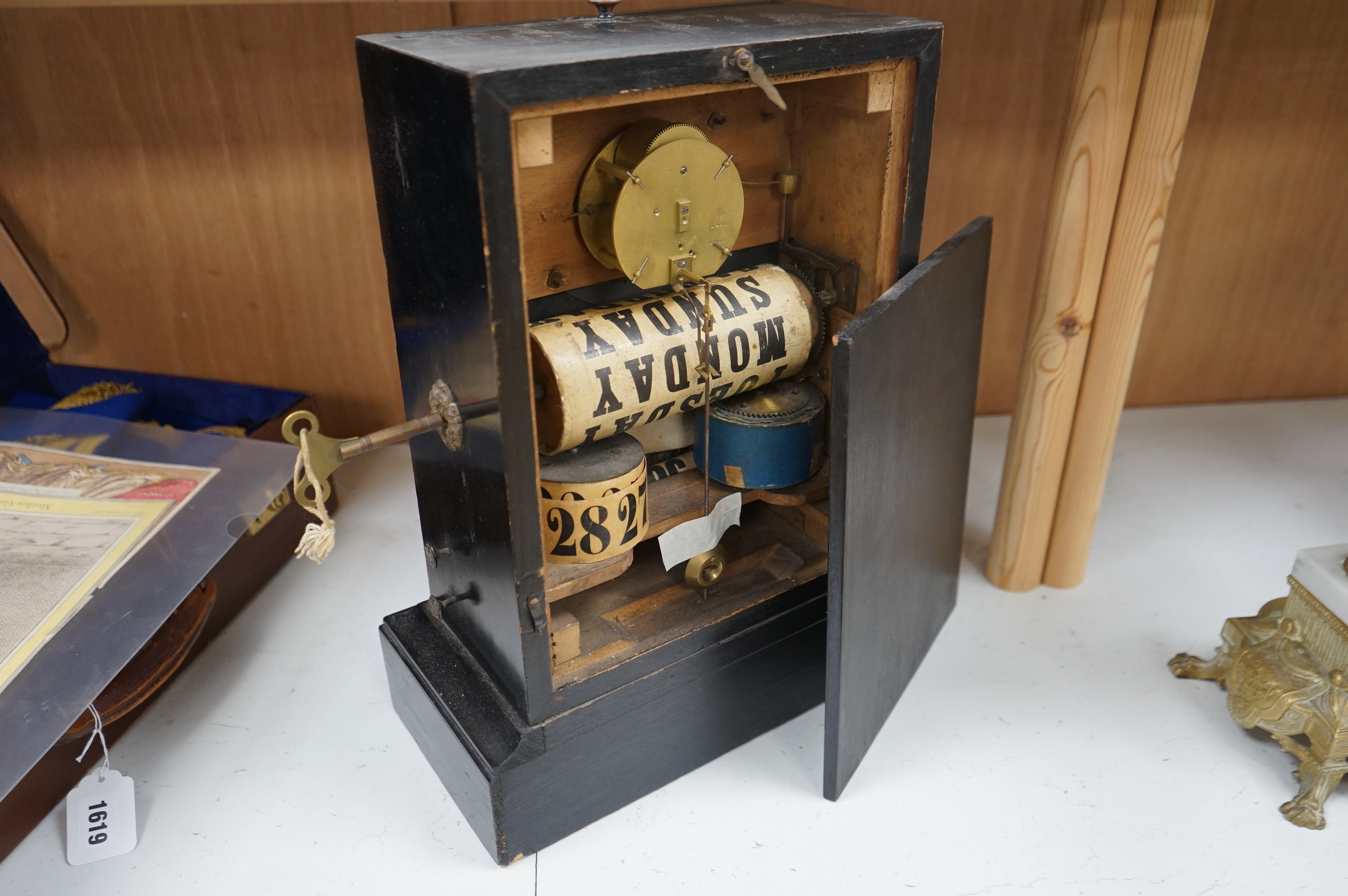 A 19th century ebonised mantel clock combined perpetual calendar with key, 43cm high. Condition - fair, untested